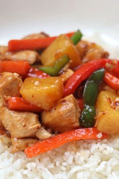 chicken, peppers and pineapples on top of white rice