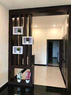 a black and white room with vases on the wall