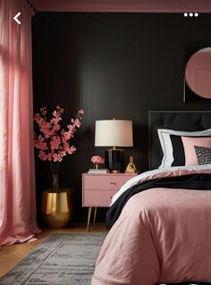 a bedroom with black walls and pink bedding