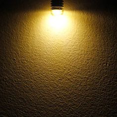 a light that is on the side of a wall in the dark with no one around it