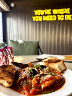 a white plate topped with lots of food on top of a table