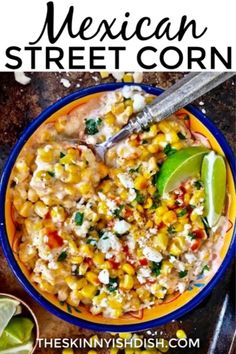 mexican street corn in a yellow and blue bowl with a lime wedge on the side