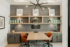 a dining room table with chairs and bookshelves