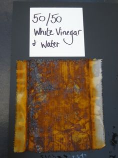 a piece of rusted metal with a sign on it that says 50 / 50 white vinegar and water