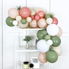 some balloons are hanging on a shelf in a room