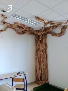 a room with a fake tree on the ceiling