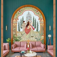 a living room filled with pink couches next to a painting on the wall above them