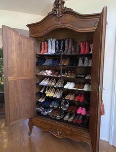 a large wooden cabinet filled with lots of pairs of shoes and an open door that says, my weekend project turned my 18th century armor into my closet i am in love