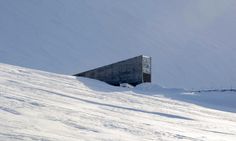 a snow covered hill with a building in the middle