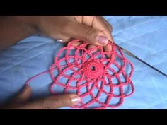 someone is crocheting an object with yarn