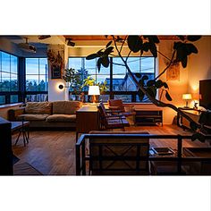 a living room filled with furniture and large windows