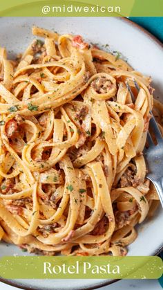 a white plate topped with pasta covered in sauce