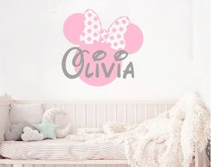 a child's bedroom with minnie mouse wall decal