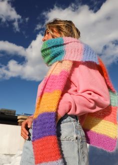 a woman wearing a multicolored knitted scarf