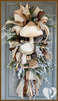 a christmas wreath on the front door with mushrooms, pine cones and other holiday decorations