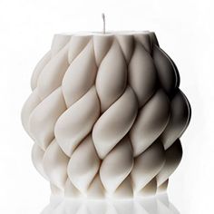 a white candle holder sitting on top of a table