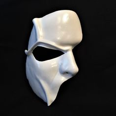 DESCRIPTIONHaunt the Paris Opera House Palais Garnier! You'll steal the stage in this extremely detailed white leather half-face mask is fabulous for theatre productions, masquerade balls, Mime costume or Halloween parties. Waterproofed, so fantastic for outdoor theater, Renaissance Festivals, or Burning Man. Any color. Waterproofed leather, glossy or matte finish, & several choices to affix the mask (cord, elastic, ribbon, waterproof cord, or no holes for adhesive). Measurements: 8" high x Artistic White Masquerade Mask For Halloween, Artistic White Costume Mask, White Eye Mask For Cosplay, White Masks For Halloween Fantasy Events, Artistic White Costume Masks And Prosthetics, Artistic White Masks And Prosthetics For Costume, White Fantasy Masks For Halloween, Artistic White Masks For Costumes, White Full Face Mask For Cosplay