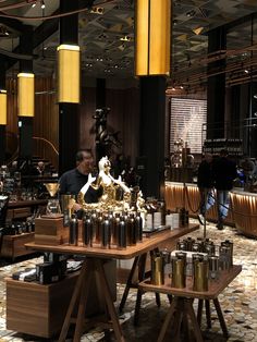 a man standing in front of a table filled with bottles