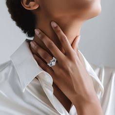 a woman wearing a diamond ring on her neck