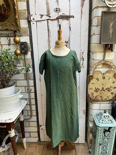 Antique French green linen shift dress initials DP size M. 100% Linen. Dyed green. Round neck and short sleeves with scallop trim, embroidered initials DP, A-line shape. Size:  Chest: 46 inches; Cuff width: 5.5 inches; Length: 45 inches. Weight: allow up to 1 kg once packed. Good condition. Green Linen Dress For Daywear, Green Linen Short Sleeve Dress, Green Linen Short Sleeve Dress For Spring, French Green, Linen Shift Dress, Embroidered Initials, Scallop Trim, Dress Clothes For Women, Petticoat