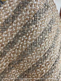 a close up view of the inside of a woven hat with an umbrella in the background