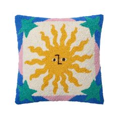 a decorative pillow with an image of the sun on it's face and eyes