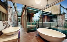 a bathroom with two sinks and a large bathtub in the middle of the room