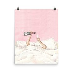 a woman laying in bed with a bottle of wine on her hand and a pink wall behind her