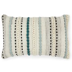 a white and blue striped pillow with black dots on the front, along with a green stripe down the middle