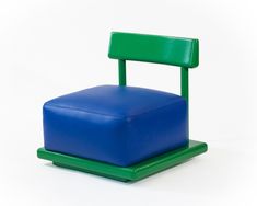 a blue and green chair sitting on top of a white floor