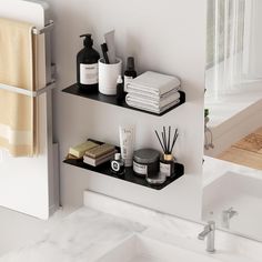 two black shelves in the bathroom are filled with personal care items