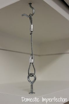 a metal object hanging from the ceiling in a room