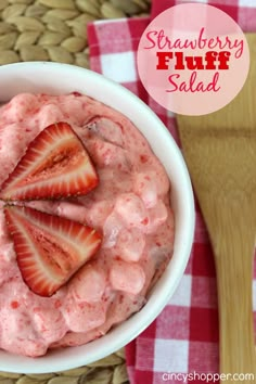 a white bowl filled with strawberry cheesecake dip