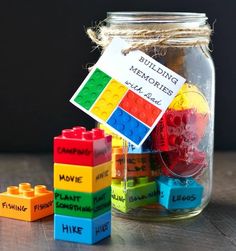 a mason jar filled with lego blocks and a father's day gift tag on top