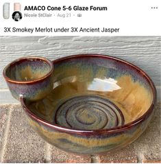 a large bowl sitting on top of a stone floor