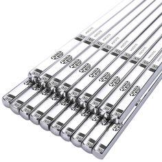 ten stainless steel kitchen utensils are lined up in a row on top of each other