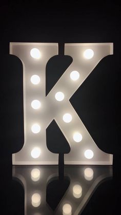 the letter k is lit up with lights