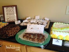 a table topped with lots of different types of cakes