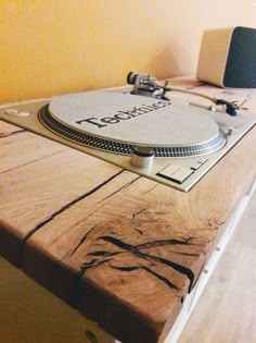 a record player sitting on top of a wooden table