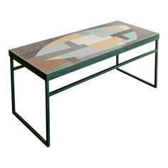 a coffee table with an abstract design on the top and metal frame, against a white background