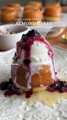 a dessert with blueberries and whipped cream on top is sitting on a white plate