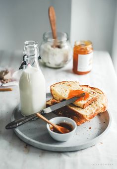 a plate that has some bread on it and a bottle of milk next to it