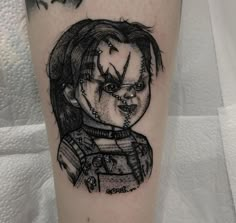 a tattoo with a drawing of a creepy clown on it's leg and the words,