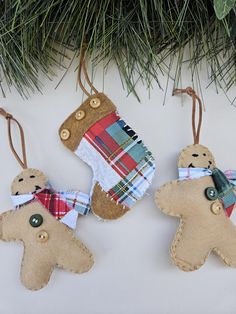 three ornaments are hanging from a christmas tree