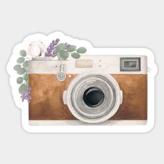 an old fashioned camera with flowers on it