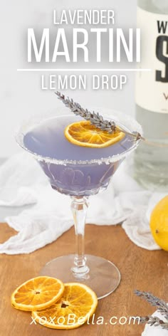 lavender martini with lemons in it on a wooden table