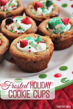 some cookies that are on a plate with white frosting and sprinkles