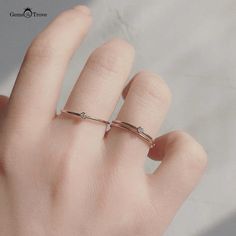 a person's hand with a ring on it