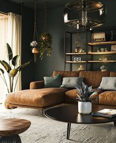 a living room filled with furniture and plants