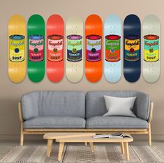 a living room filled with furniture and lots of skateboards hanging on the wall above it